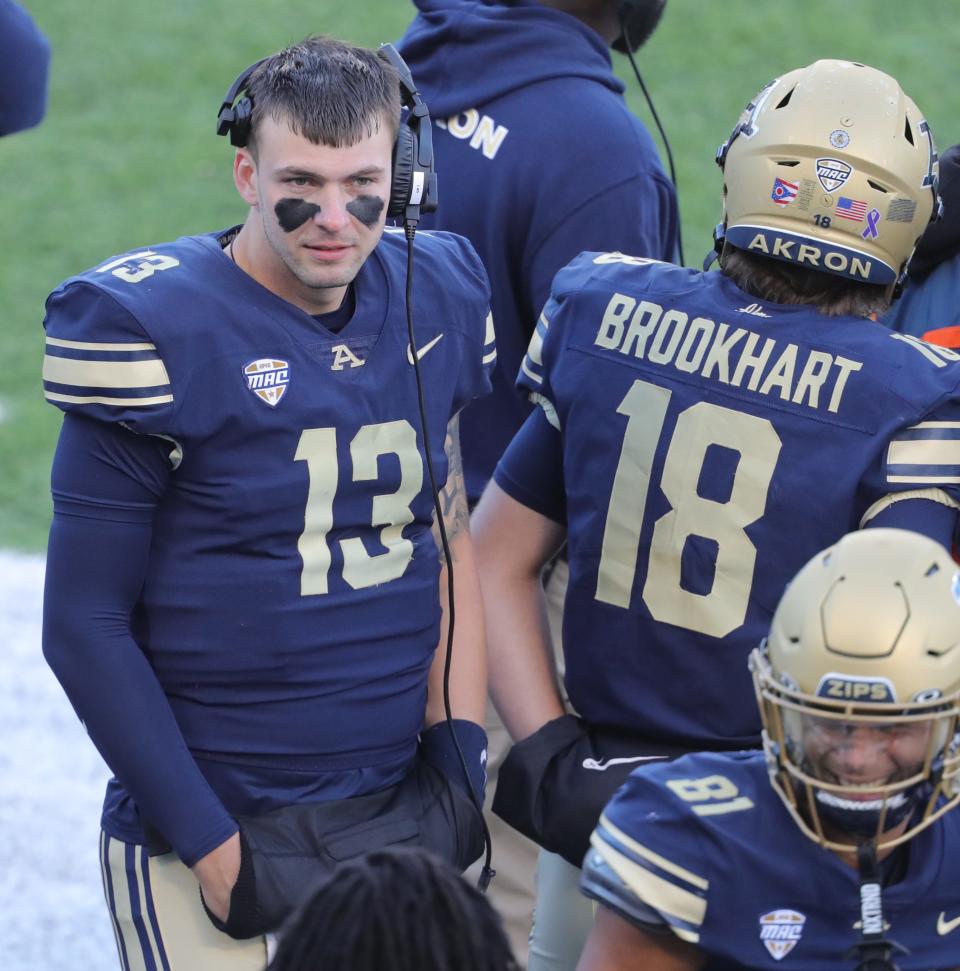 University of Akron quarterbacks Jeff Undercuffler Jr. and Johnny Brookhart on the sidelines during the second quarter against NIU on Saturday in Akron.