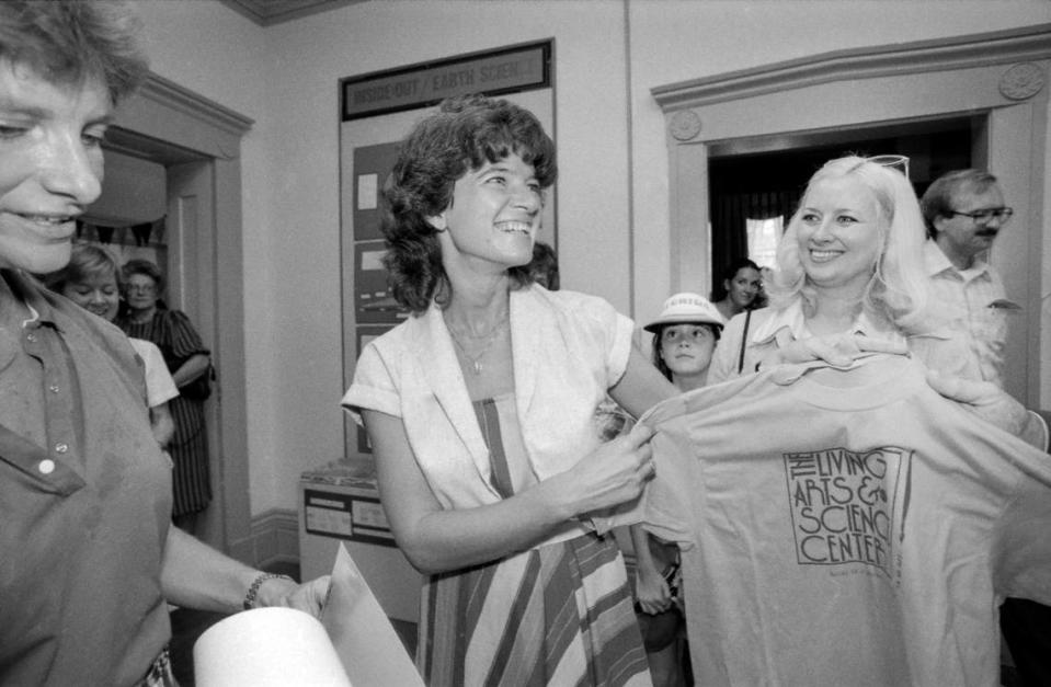 Sally Ride, the first American woman in space, received a t-shirt from Ruth Ann Palumbo at the Living Arts and Science Center in Lexington, Ky. on Thursday, Aug. 25, 1983. Ride visited made several stops in Lexington that day, preaching the wonders of space travel. In the background, in between Ride and Palumbo, is Aoife Lyons, daughter of Alltech founder Pearse Lyons.