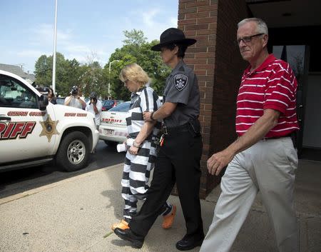 Joyce Mitchell is escorted out of the court house after pleading guilty at Clinton County court, in Plattsburgh, New York July 28, 2015. REUTERS/Christinne Muschi