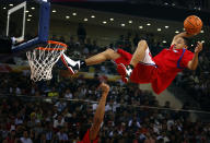 A stunt performer prepares to dunk during a break in the first of the NBA China Games between the Miami Heat and the Los Angeles Clippers at Wukesong arena in Beijing October 11, 2012. REUTERS/David Gray (CHINA - Tags: SPORT BASKETBALL)