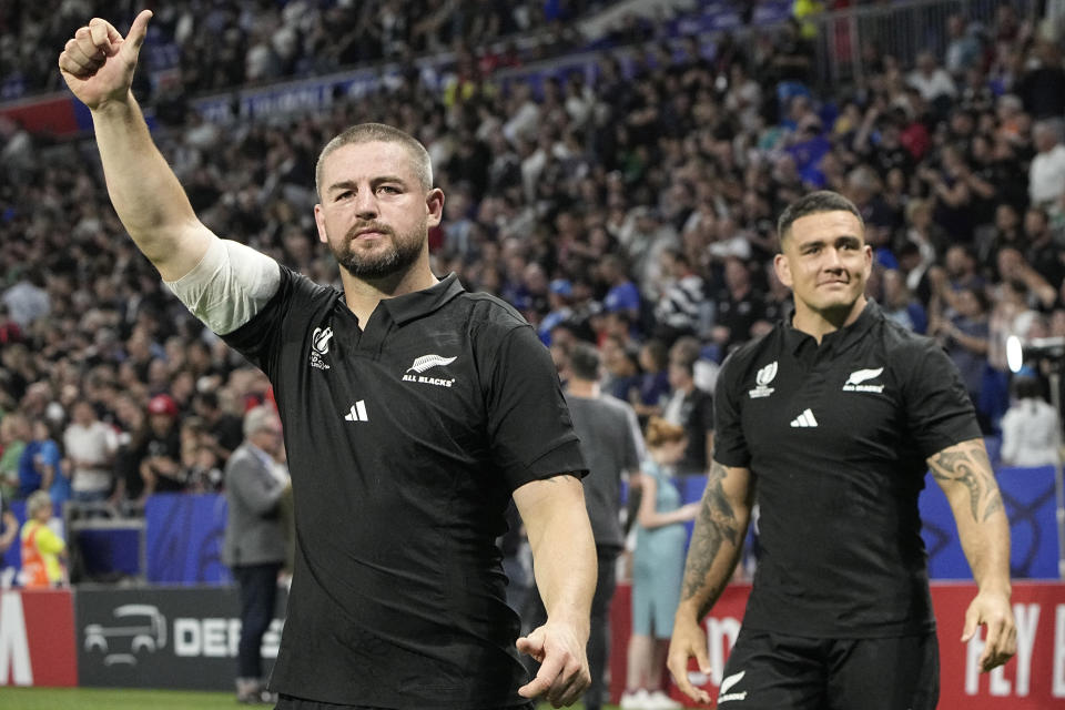 FILE - New Zealand's Dane Coles, left, with Codie Taylor, right, react after the Rugby World Cup Pool A match between New Zealand and Italy at the OL Stadium in Lyon, France, Friday, Sept. 29, 2023. All Blacks hooker Dane Coles, Wallabies flyhalf Bernard Foley and Wales fullback Liam Williams all are now playing for Kubota Spears Funabashi Tokyo Bay in Japan League One. (AP Photo/Laurent Cipriani, File)