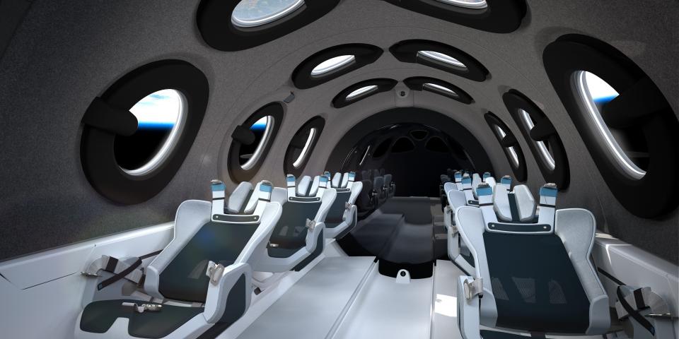 The interior of Virgin Galactic's spacecraft, the VSS Unity, which features a handful of seats and several circular viewing windows.