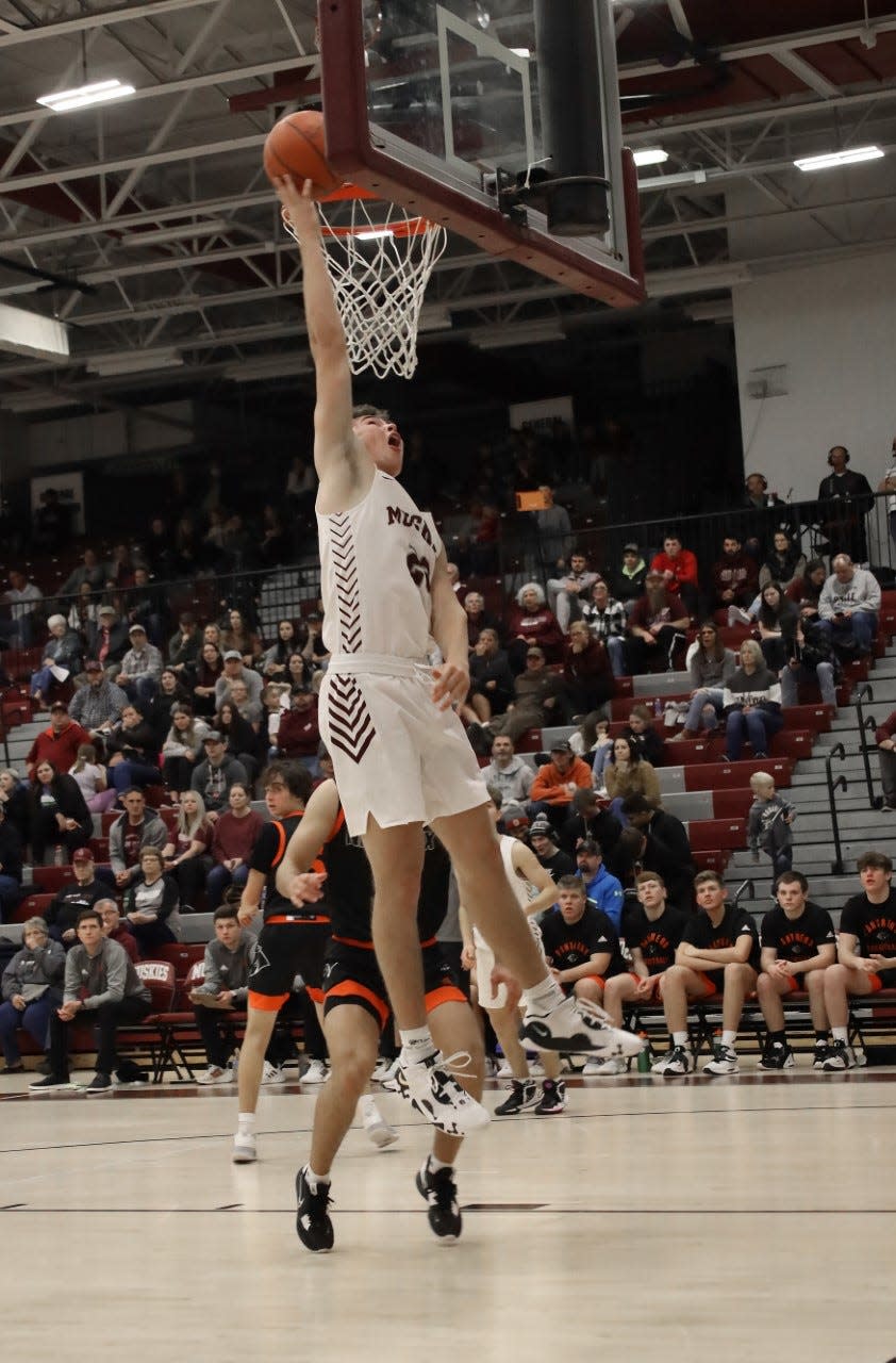 John Glenn senior Nathan Walker goes up for two of his team-high 18 points during Friday's 61-49 MVL victory over visiting New Lexington in New Concord.