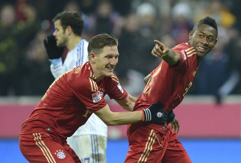 Bayern Munich's midfielder Bastian Schweinsteiger (L) and his teammate David Alaba celebrate after the third goal for Munich during their German first division Bundesliga football match against Schalke 04 in Munich, southern Germany, on February 9, 2013. Bayern Munich extend their lead at the top of the Bundesliga to 15 points following their 4-0 rout of Schalke 04