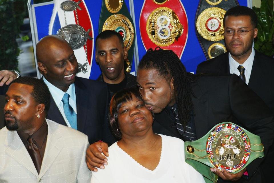 Lennox Lewis kisses his mother after announcing his retirement during a press conference at London’s Grosvenor House Hotel on February 2004.