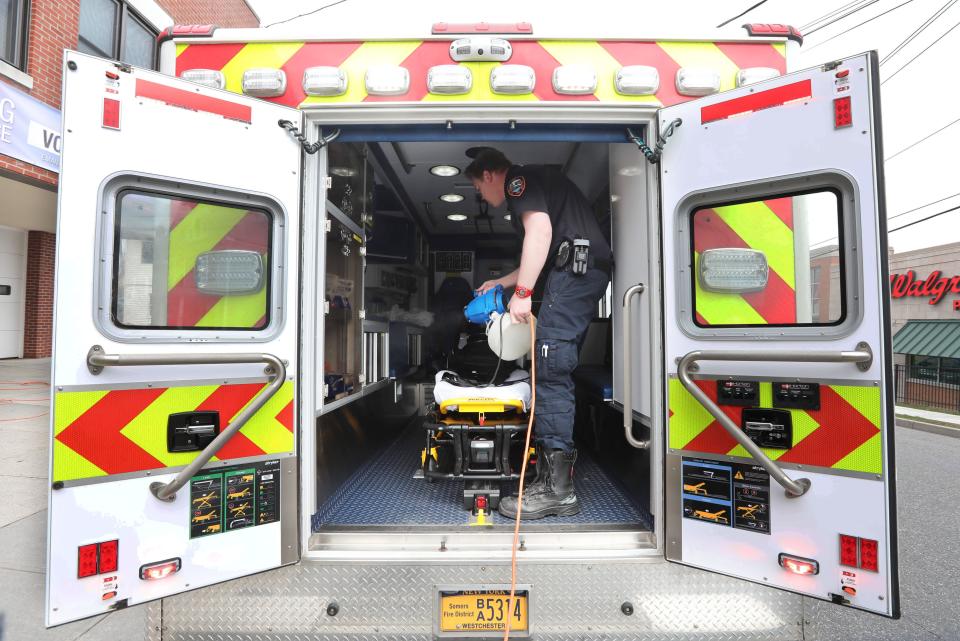 Kyle Spitzfaden, operations supervisor for the Ossining Volunteer Ambulance Corps, sprays disinfectant inside a Somers Volunteer Fire Department ambulance outside the Ossining ambulance corps headquarters April 5, 2020.