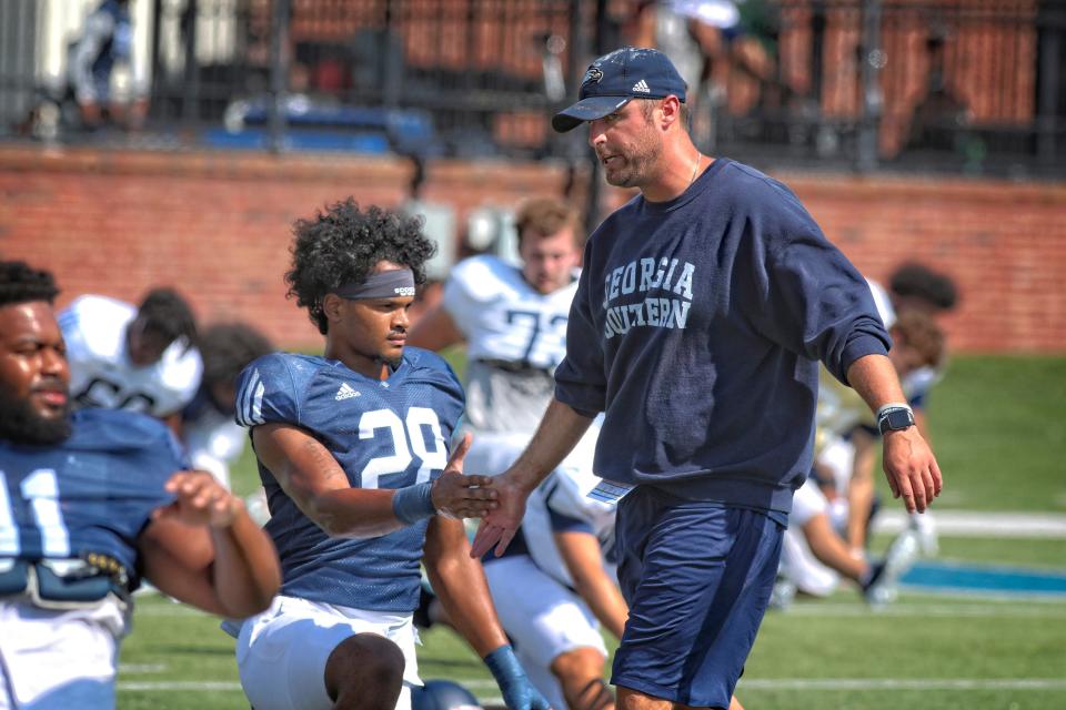 Georgia Southern linebackers coach Aaron Schwanz slaps hands with linebacker Zyere Horton (28) during practice on Aug. 17, 2022 at Paulson Stadium in Statesboro.