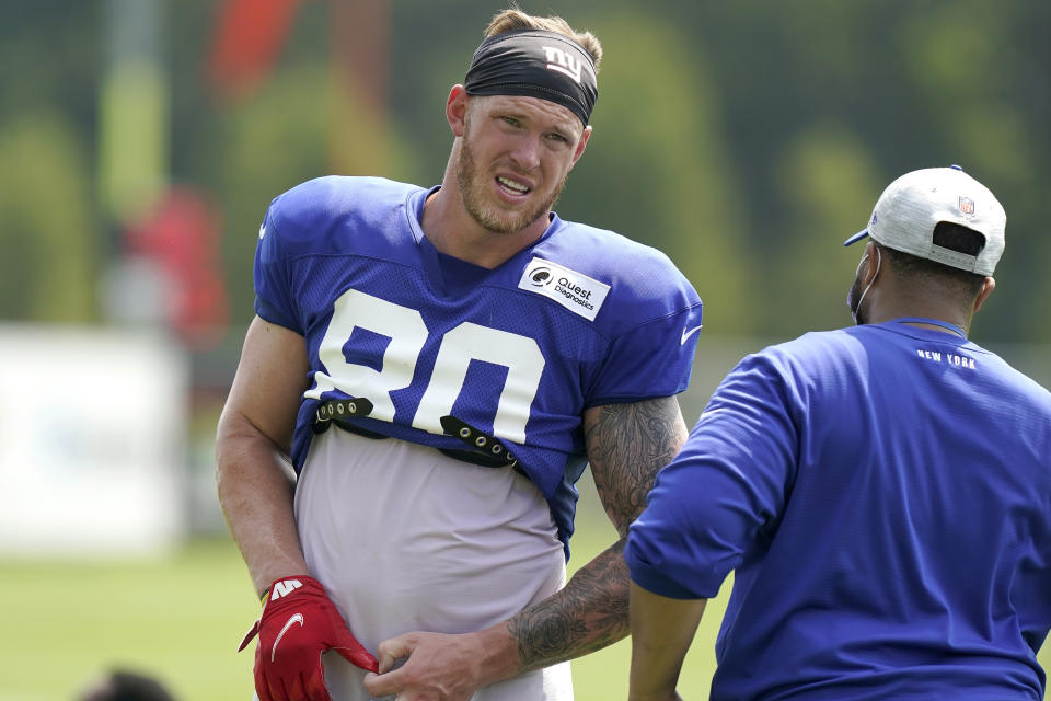 FILE - In this Aug. 25, 2021, file photo, New York Giants tight end Kyle Rudolph (80) removes his gloves before facing reporters following a joint NFL football practice with the New England Patriots in Foxborough, Mass. Rudolph signed as a free agent in the offseason. He did not play in any of the three preseason games because of offseason surgery on his foot. (AP Photo/Steven Senne, File)