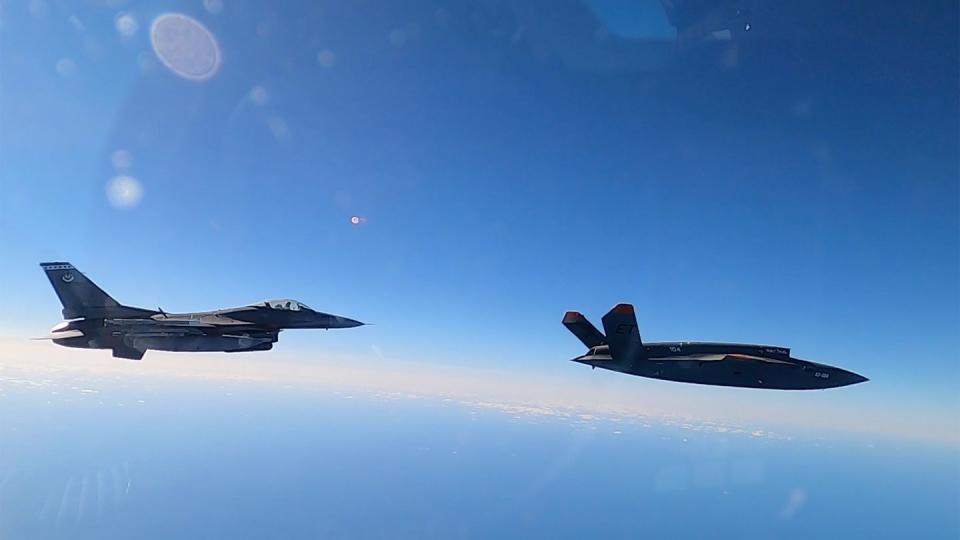 An XQ-58A Valkyrie flies alongside an F-16 Fighting Falcon during a Dec. 15, 2022, test conducted by the 40th Flight Test Squadron at Eglin Air Force Base in Florida. (Samuel King Jr./U.S. Air Force)