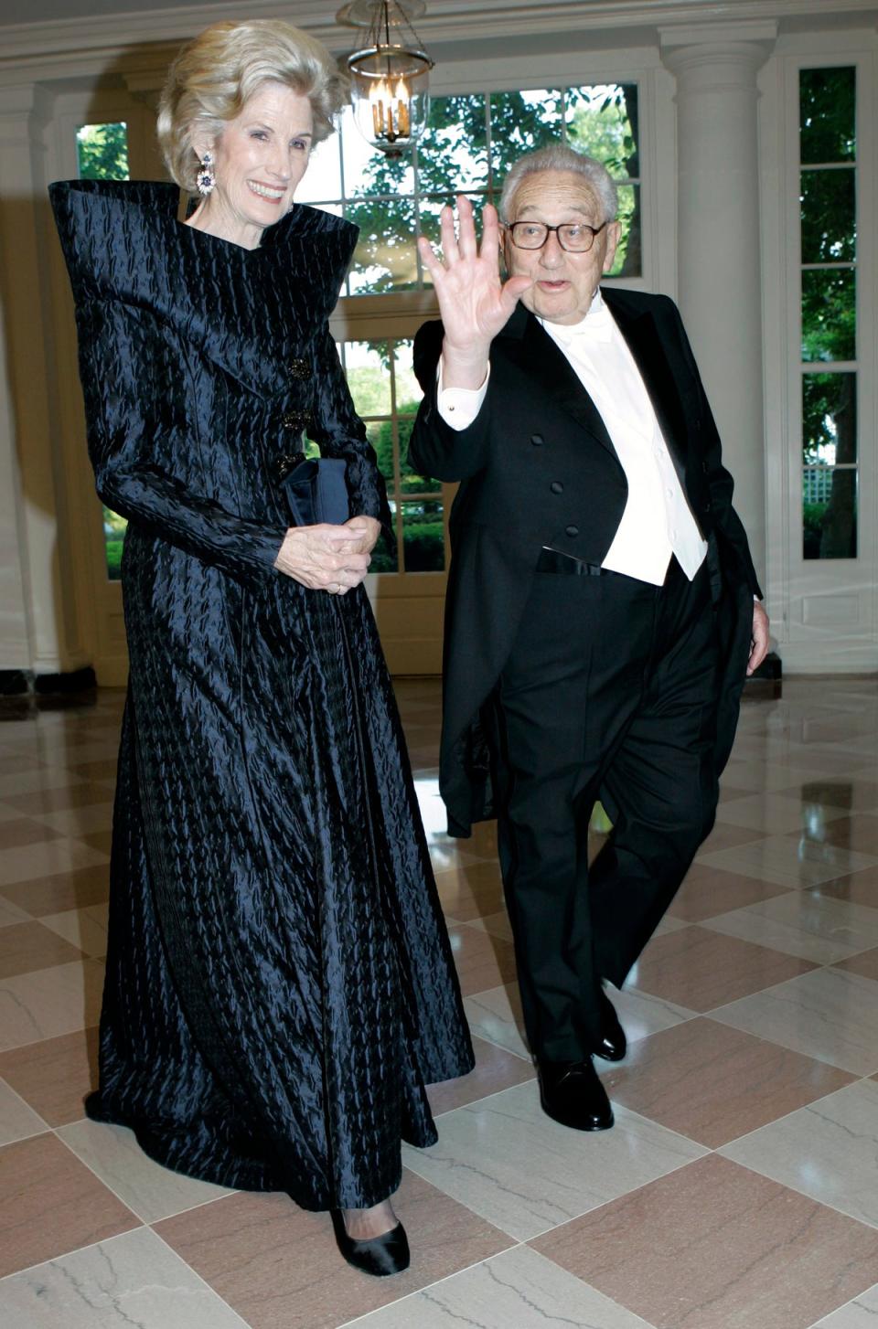 Henry Kissinger, right, and his wife Nancy walk through the Booksellers Area as they arrive for the State Dinner in honor of Queen Elizabeth II and her husband Prince Philip, May 7, 2007, at the White House in Washington. (AP)