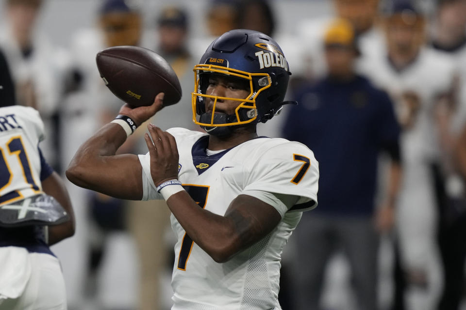 Toledo quarterback Dequan Finn throws during the first half of the Mid-American Conference championship NCAA college football game against Ohio, Saturday, Dec. 3, 2022, in Detroit. (AP Photo/Carlos Osorio)