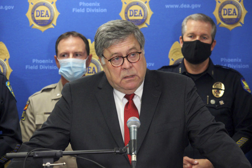U.S. Attorney General William Barr speaks at a news conference, Thursday, Sept. 10, 2020, in Phoenix, where he announced results of a crackdown on international drug trafficking. Barr spent much of his time attacking mail-in voting, defending a Justice Department decision to take over defense of President Trump in a defamation case and discussing the civil unrest triggered by the killing of George Floyd by Minneapolis police in May. (AP Photo/Bob Christie)
