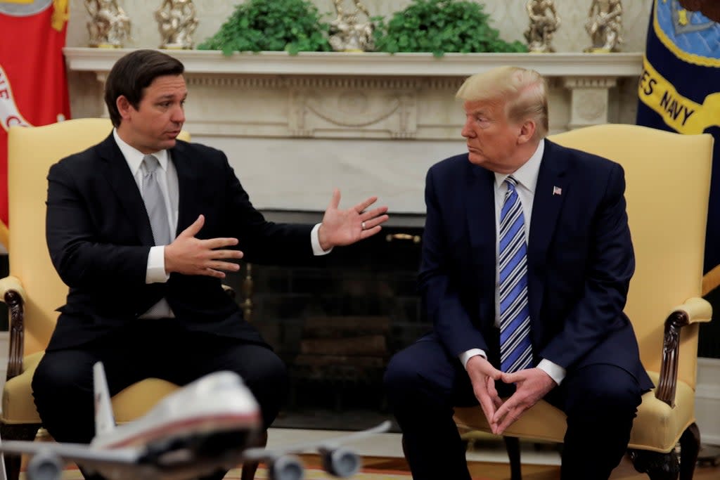 Ron DeSantis and Donald Trump discussing the Covid crisis in the White House. Both men are thought to want to return to 1600 Pennsylvania Avenue on a more permanent basis  (REUTERS)