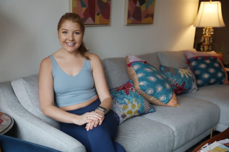 Lauren Maginness poses wearing Dupes, short for duplicate, at her apartment in New York City