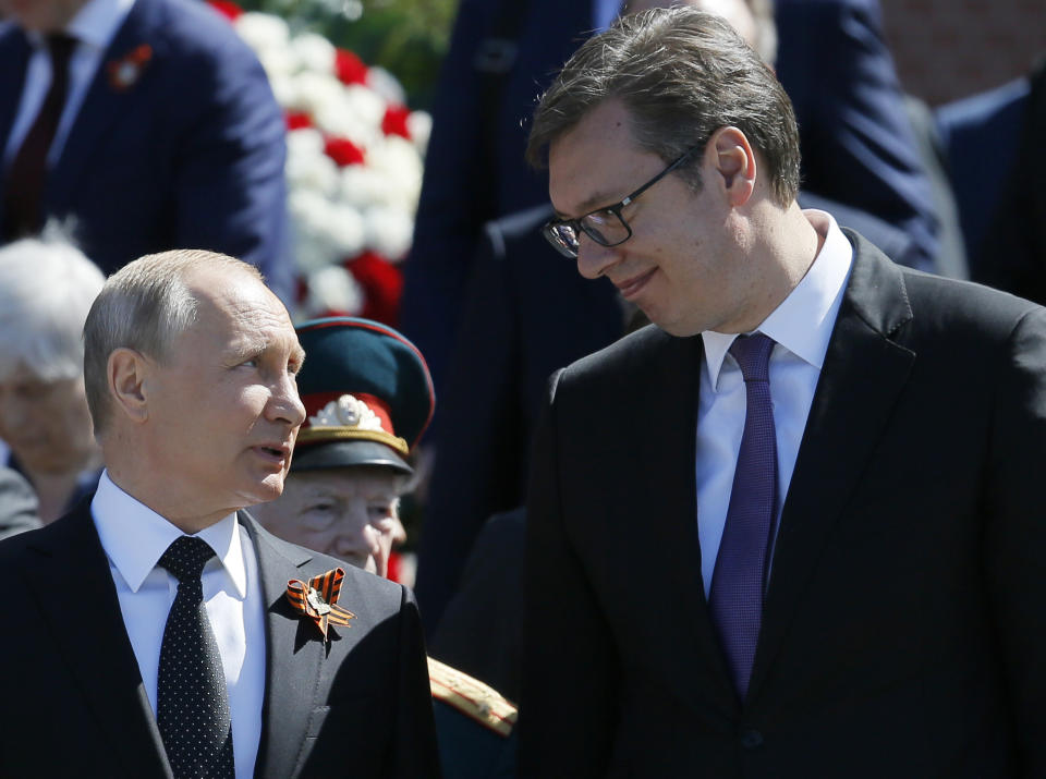 FILE - In this file photo taken on Wednesday, May 9, 2018, Russian President Vladimir Putin, left, and Serbian President Aleksandar Vucic, talk after the wreath-laying ceremony at the Tomb of the Unknown Soldier after the Victory Parade marking the 73th anniversary of the defeat of the Nazis in World War II, in Moscow, Russia. A massive military parade that was postponed by the coronavirus will roll through Red Square this week to celebrate the 75th anniversary of the end of World War II in Europe, even though Russia is continuing to register a steady rise in infections. (AP Photo/Alexander Zemlianichenko, File)