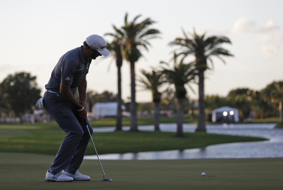 Dustin Johnson watches his putt on the 18th green during the second round of the Cadillac Championship golf tournament Friday, March 7, 2014, in Doral, Fla. Johnson bogeyed the hole. (AP Photo/Wilfredo Lee)
