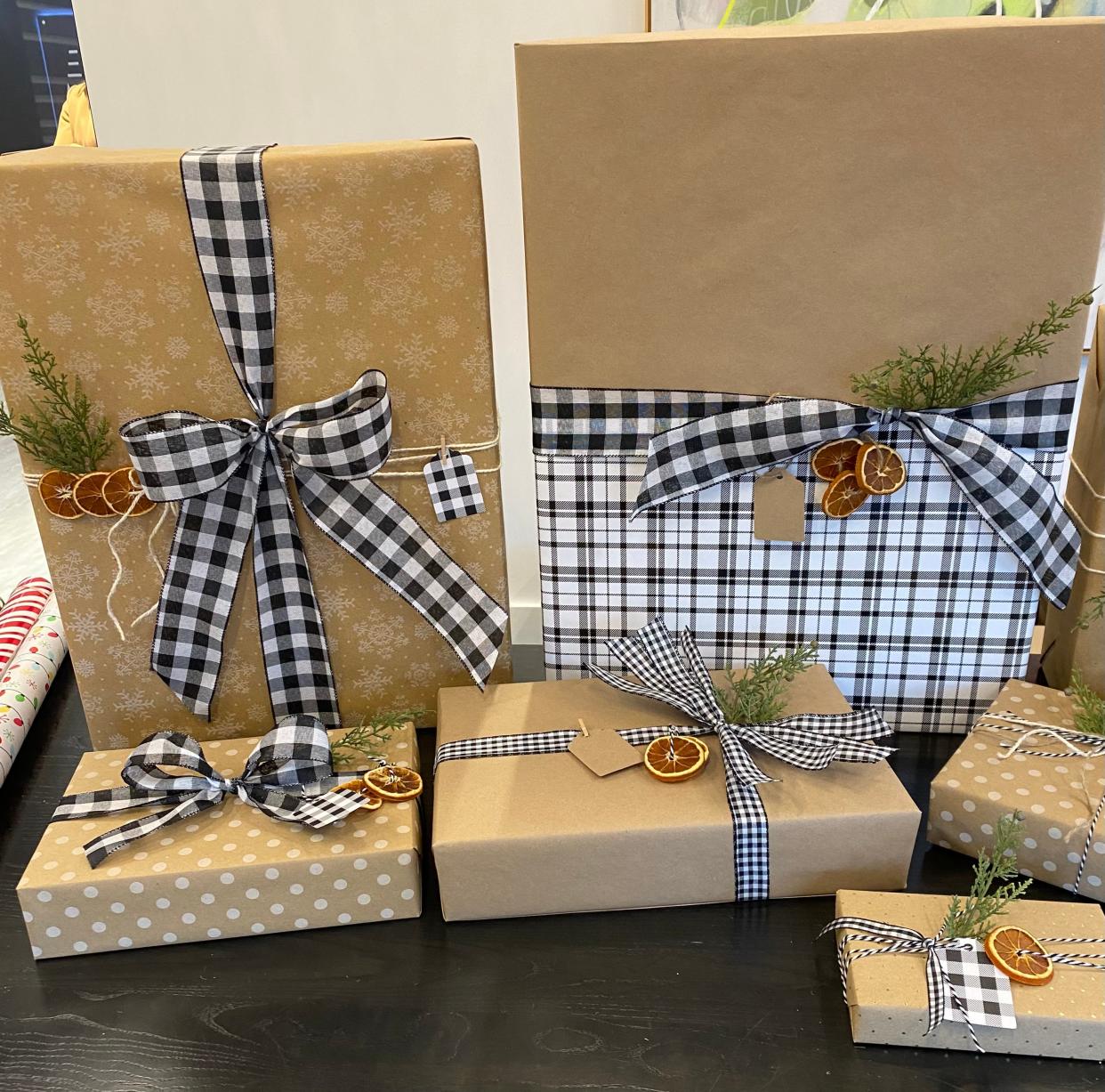 Amber Blakley wrapped this set of gifts from a client who requested a natural theme Wednesday, Dec. 20, 2023, at Evans May Wealth in Carmel.