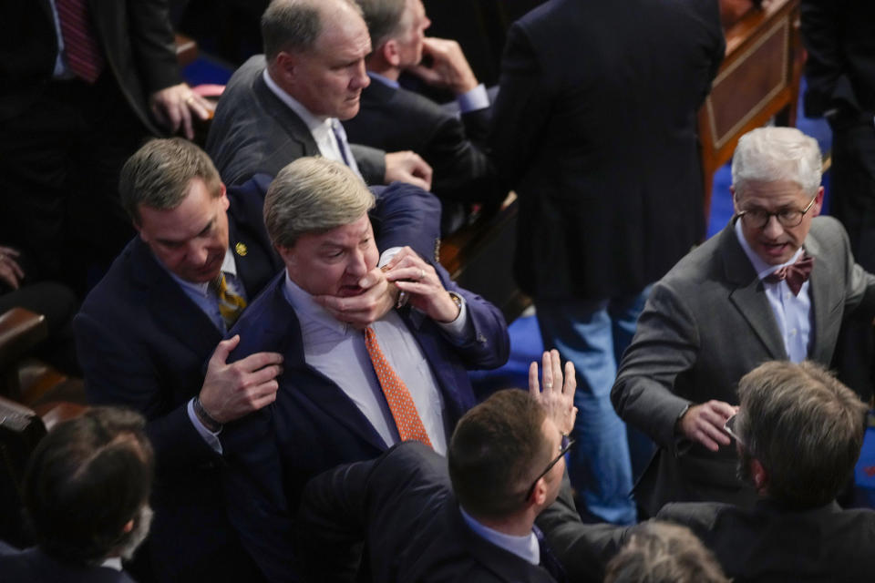 Rep. Richard Hudson, left, pulls Rep. Mike Rogers back as they talk with Rep. Matt Gaetz following the 14th round of voting for House speaker on Friday, Jan. 6, 2023.