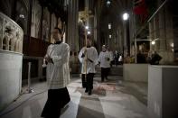 Choir boys walk in during Midnight Mass at St. Patrick's Cathedral on Christmas Day in New York, December 25, 2013. REUTERS/Carlo Allegri (UNITED STATES - Tags: SOCIETY RELIGION)