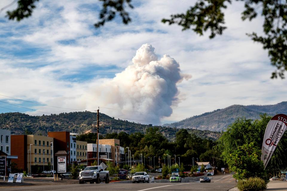 Viewed from Oakhurst in Madera County, Calif., a plume rises from the Washburn Fire burning in Yosemite National Park on Friday, July 8, 2022. 