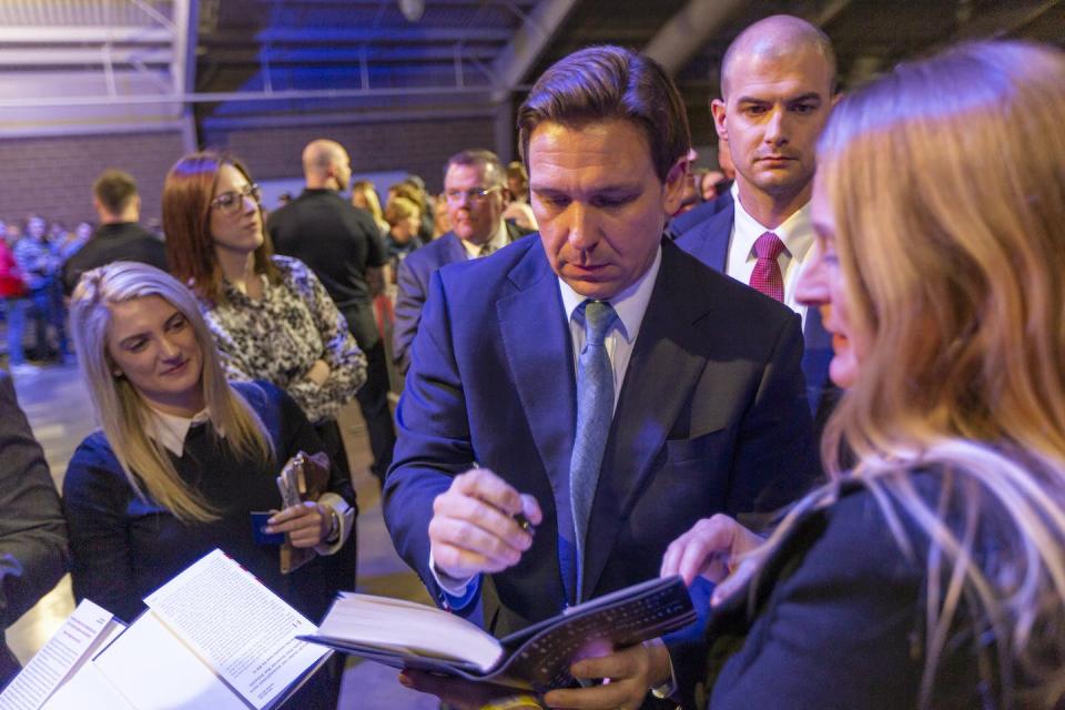 Florida Gov. Ron DeSantis signs a copy of his book in Des Moines, Iowa, on March 10, 2023. <a href="https://www.gettyimages.com/detail/news-photo/florida-gov-ron-desantis-signs-books-in-des-moines-on-march-news-photo/1248482975?phrase=Ron" rel="nofollow noopener" target="_blank" data-ylk="slk:Rachel Mummey/The Washington Post via Getty Images;elm:context_link;itc:0;sec:content-canvas" class="link ">Rachel Mummey/The Washington Post via Getty Images</a>