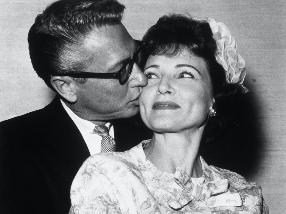 Allen Ludden kisses Betty White's cheek on their wedding day.