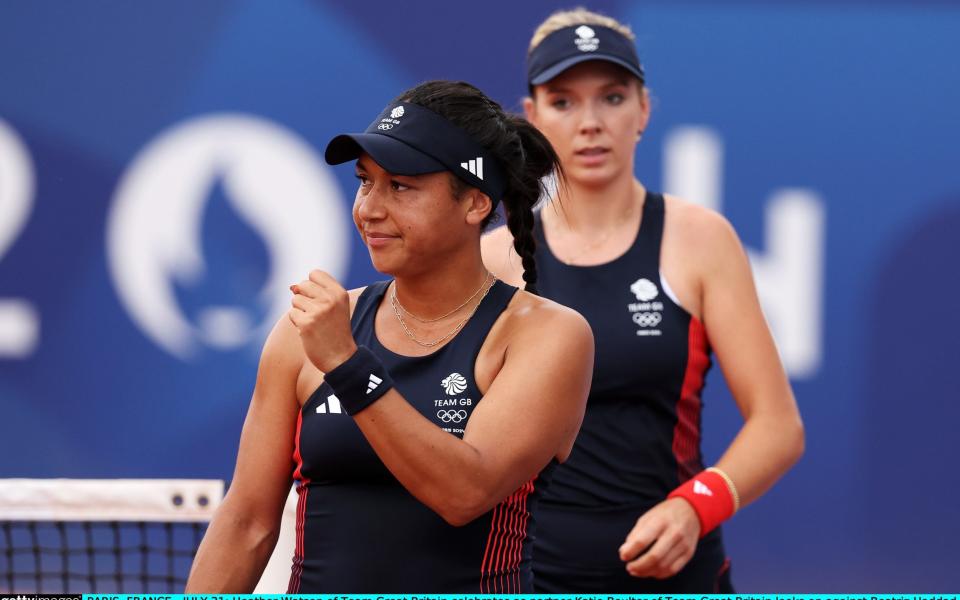 Heather Watson celebrates with Katie Boulter in the background