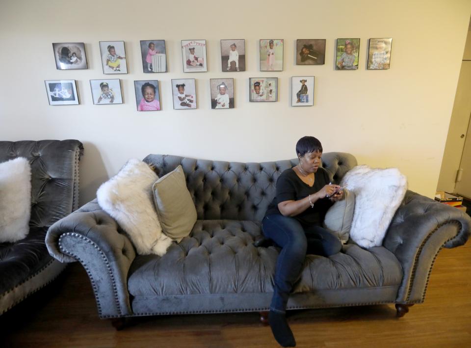 Nicole Johnson sits under photos of her daughter Khloe in her White Plains home Oct. 14, 2020. Johnson, who had worked for the past eight years as a teacher's aide, was forced to give up her job in order to care for her daughter, a second-grader in the White Plains school district who is doing all virtual learning due to the COVID-19 pandemic.