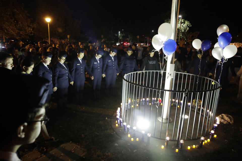 Members of Saugus High School's Air Force JUNIOR ROTC unit hold a moment of silence in memory of the victims of a shooting at the school earlier in the day Thursday, Nov. 14, 2019, in Santa Clarita, Calif. Los Angeles County sheriff’s officials say a 16-year-old student shot five classmates and then himself in a quad area of Saugus High School Thursday morning. (AP Photo/Marcio Jose Sanchez)