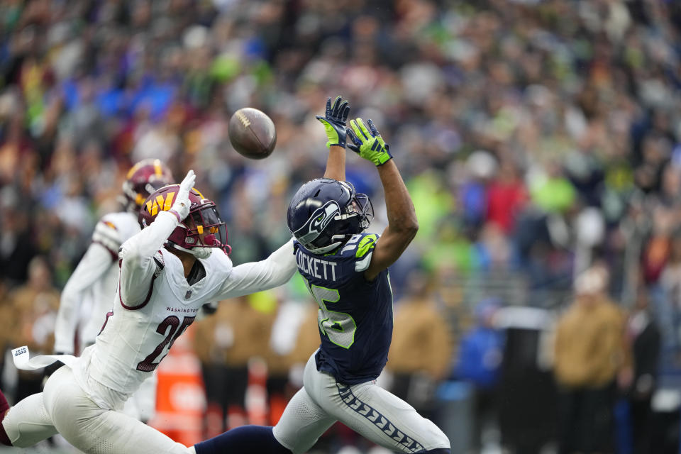 Washington Commanders cornerback Benjamin St-Juste (25) breaks up a pass against Seattle Seahawks wide receiver Tyler Lockett (16) in the first half of an NFL football game in Seattle, Sunday, Nov. 12, 2023. (AP Photo/Lindsey Wasson)
