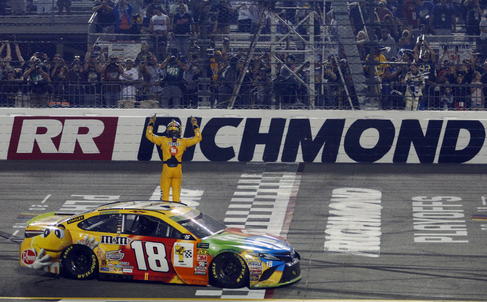 Kyle Busch (18) celebrates winning the NASCAR Cup Series auto race at Richmond Raceway in Richmond, Va., Saturday, Sept. 22, 2018. (AP Photo/Steve Helber)