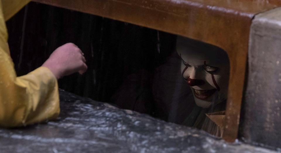 Pennywise lurks beneath the street in 'It' (WB)