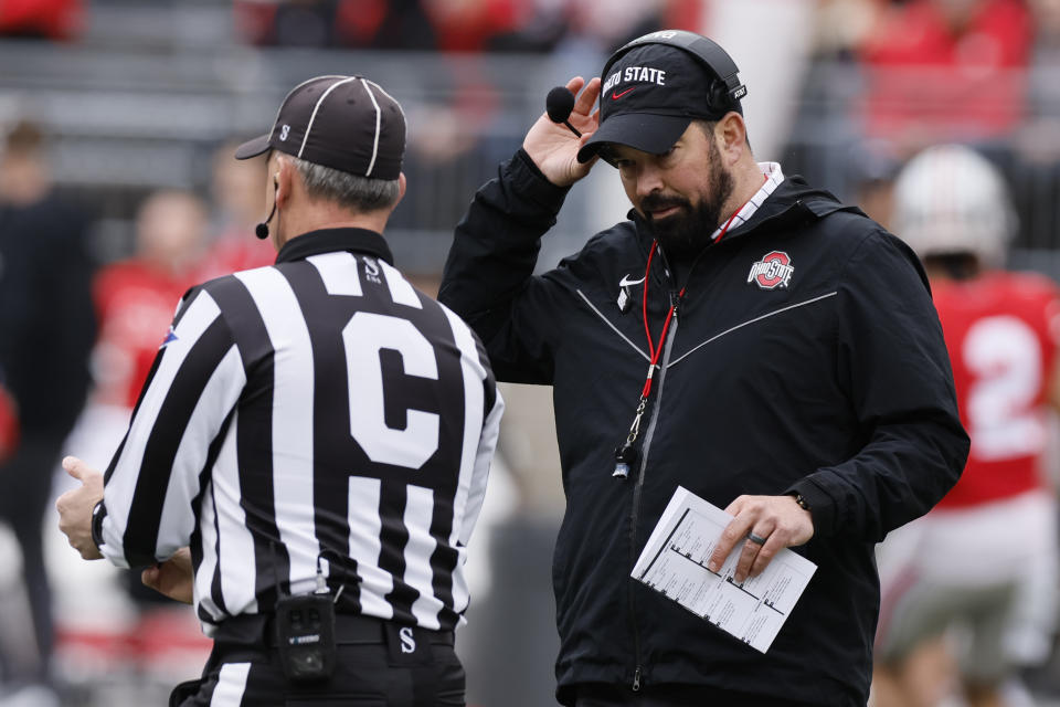 FILE — Ohio State head coach Ryan Day, right, talks with a referee during an NCAA college spring football game in this April 16, 2022 file photo, in Columbus, Ohio. The pain of Ohio State's loss to Michigan last season remains for the Buckeyes, who can't wait to try to avenge the loss. (AP Photo/Jay LaPrete, File)