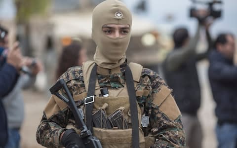 A convoy of American Special Forces and Syrian Democratic Forces fighters makes a stop during a patrol near the Turkish border in northern Syria - Credit:  Sam Tarling