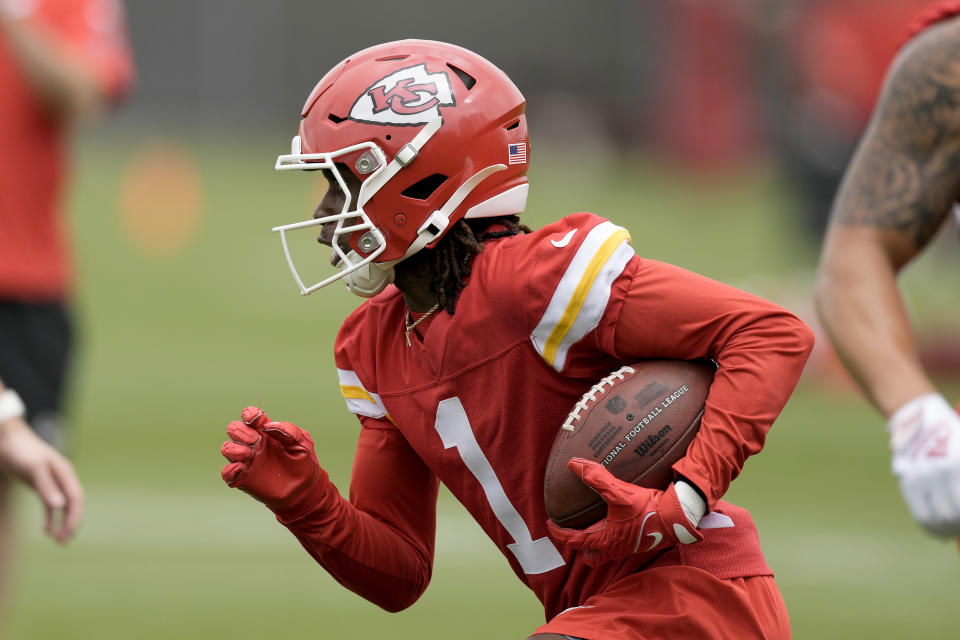 Kansas City Chiefs running back Xavier Worthy runs the ball during the NFL football team's rookie minicamp Monday, May 6, 2024, in Kansas City, Mo. (AP Photo/Charlie Riedel)