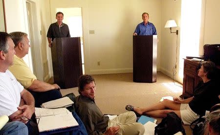 George W. Bush and Judd Gregg practice with Bush staff members for upcoming presidential debates against Al Gore, at Bush's ranch in Crawford. REUTERS/Jeff Mitchell