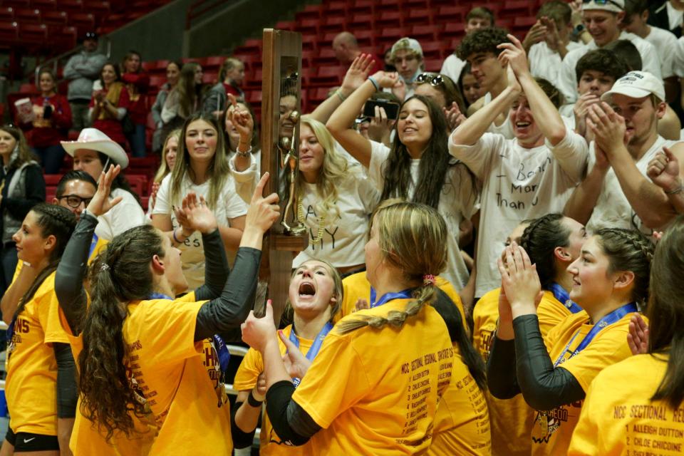 McCutcheon players celebrate after defeating Castle, 3-0, to win the IHSAA Class 4a volleyball state finals, Saturday, Nov. 6, 2021 at Ball State University's Worthen Arena in Muncie.