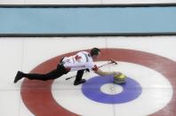 Canada's second E.J. Harnden delivers a stone during their men's curling round robin game against the U.S. in the Ice Cube Curling Centre at the Sochi 2014 Winter Olympic Games February 16, 2014. REUTERS/Ints Kalnins (RUSSIA - Tags: SPORT OLYMPICS SPORT CURLING)