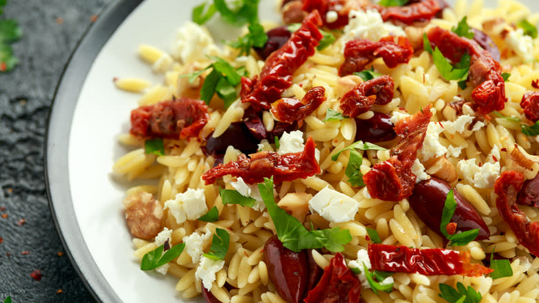 orzo pasta with sun dried tomatoes, olives, feta and herbs