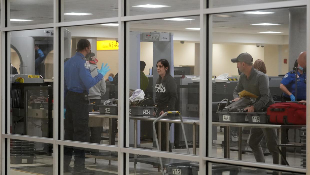 A Transportation Security Administration officer gives instructions to travelers on Tuesday, Jan. 9, 2024, at John Glenn Columbus International Airport.
