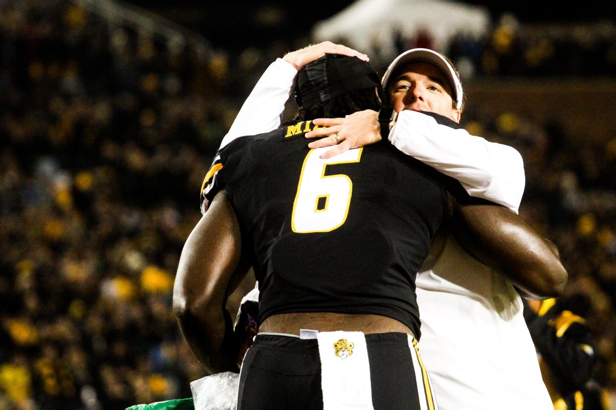 Missouri head coach Eli Drinkwitz hugs senior defensive lineman Darius Robinson before a college football game at Memorial Stadium on Nov. 18, 2023, in Columbia, Mo.