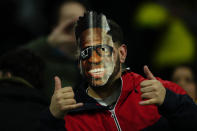 A Brazilian fan wearing a Vinicius Jr. mask gives the thumbs up before the start of a friendly soccer match between Spain and Brazil at the Santiago Bernabeu stadium in Madrid, Spain, Tuesday, March 26, 2024. (AP Photo/Jose Breton)