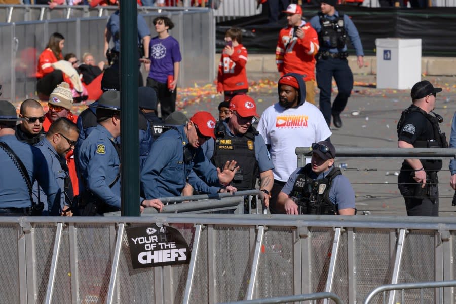 Law enforcement personnel investigate following a shooting at the Kansas City Chiefs NFL football Super Bowl celebration in Kansas City, Mo., Wednesday, Feb. 14, 2024. Multiple people were injured, a fire official said.(AP Photo/Reed Hoffmann)