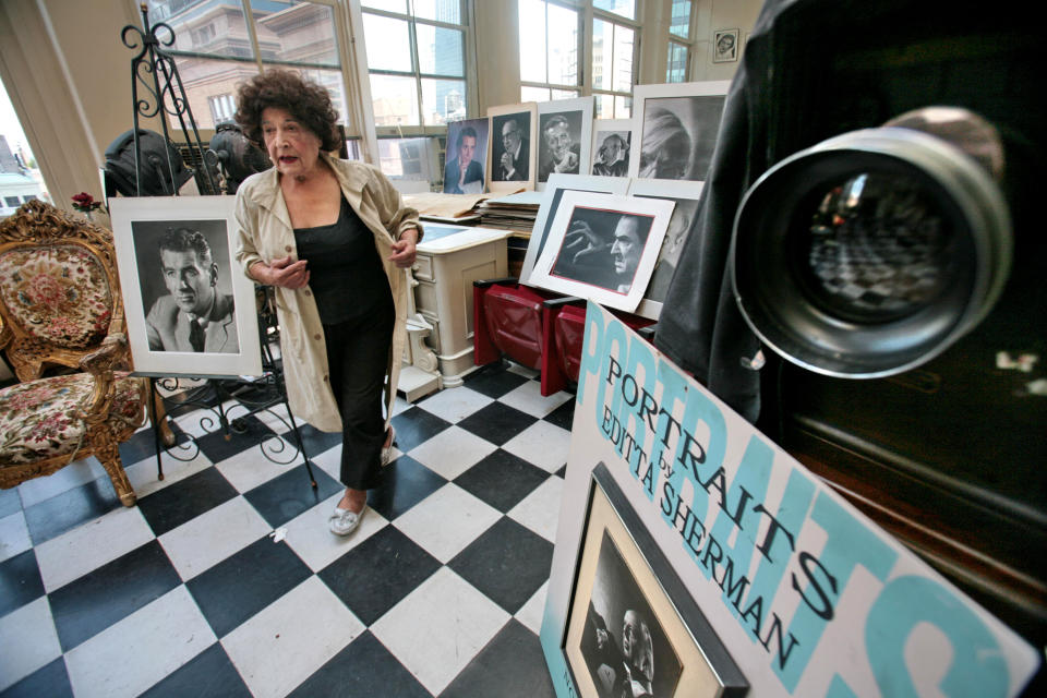 FILE - In this Aug. 2 , 2007 file photo, Editta Sherman is surrounded by her work and a vintage view camera at her portrait photography studio residence in New York. Sherman, dubbed the "Duchess of Carnegie Hall," because she lived above the famed New York City hall for six decades, died Friday, Nov. 2, 2013 in her sleep, said Billy Lyons, an actor and Sherman's friend. She was 101. (AP Photo/Bebeto Matthews, File)