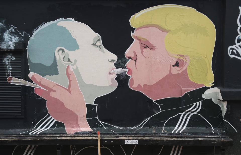 A mural depicts President Donald Trump blowing marijuana smoke into the mouth of Russian President Vladimir Putin on the wall of restaurant in Vilnius, Lithuania, on Nov. 23, 2016.