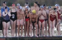 Swimmers wait to dive into the Serpentine river on Christmas Day in Hyde Park, central London December 25, 2013. For over 100 years, swimmers have taken part in the Christmas Day "Peter Pan" swim in the Serpentine. REUTERS/Suzanne Plunkett (BRITAIN - Tags: SOCIETY SPORT SWIMMING)