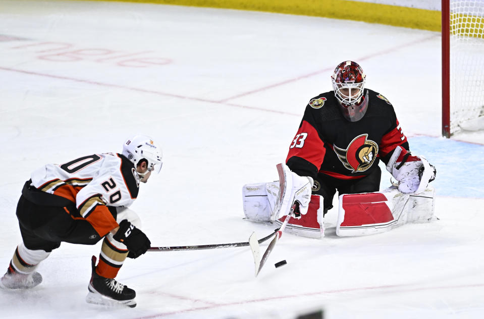 Ottawa Senators goaltender Cam Talbot (33) comes out from his crease to make a save against Anaheim Ducks right wing Brett Leason (20) during the third period of an NHL hockey game in Ottawa, Ontario, Monday, Dec. 12, 2022. (Justin Tang/The Canadian Press via AP)