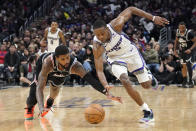 Los Angeles Clippers forward Paul George, left, and Sacramento Kings guard De'Aaron Fox go after a loose ball during the second half of an NBA basketball game Friday, Feb. 24, 2023, in Los Angeles. (AP Photo/Mark J. Terrill)