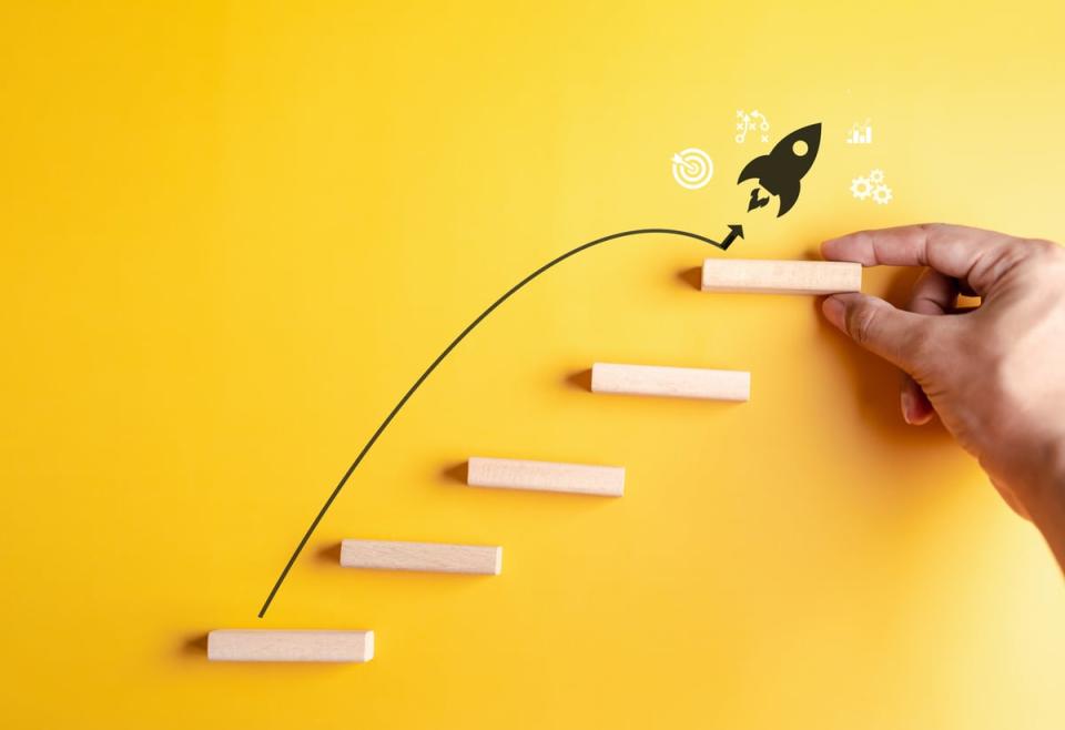 A rocket symbol jumping from platform to platform against a yellow background.