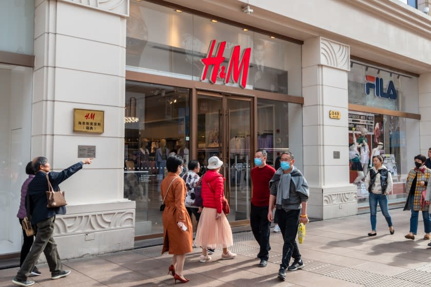 SHANGHAI, CHINA - MARCH 24, 2021 - Citizens walk past an H&M store on Nanjing Road pedestrian street in Shanghai, China, March 24, 2021. (Photo credit should read Costfoto/Barcroft Media via Getty Images)